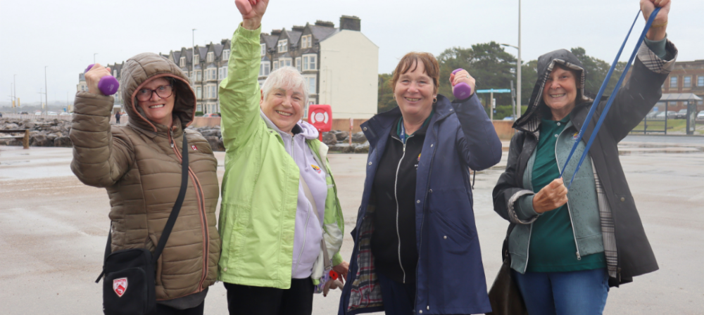 Group of women raising their arms