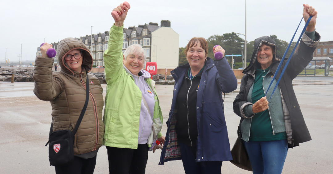 Group of women raising their arms