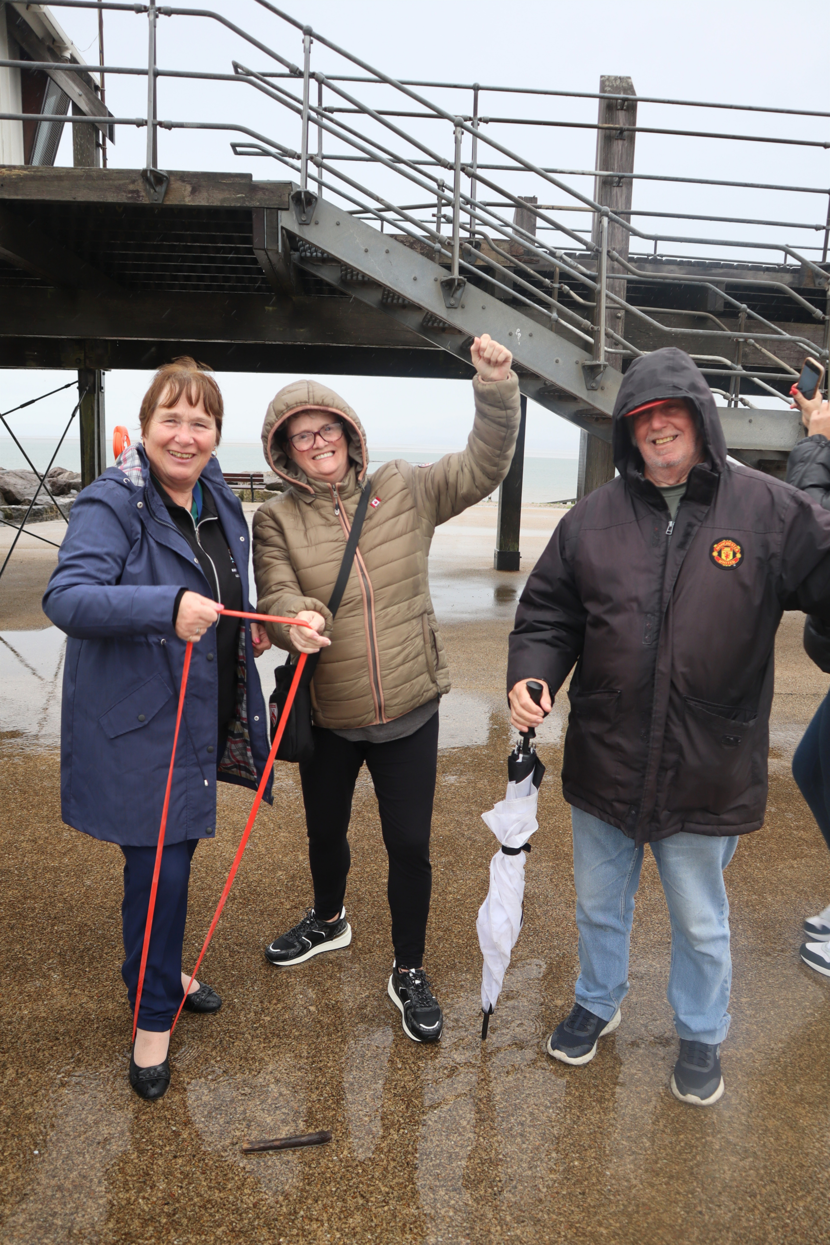 Three people posing with walking poles
