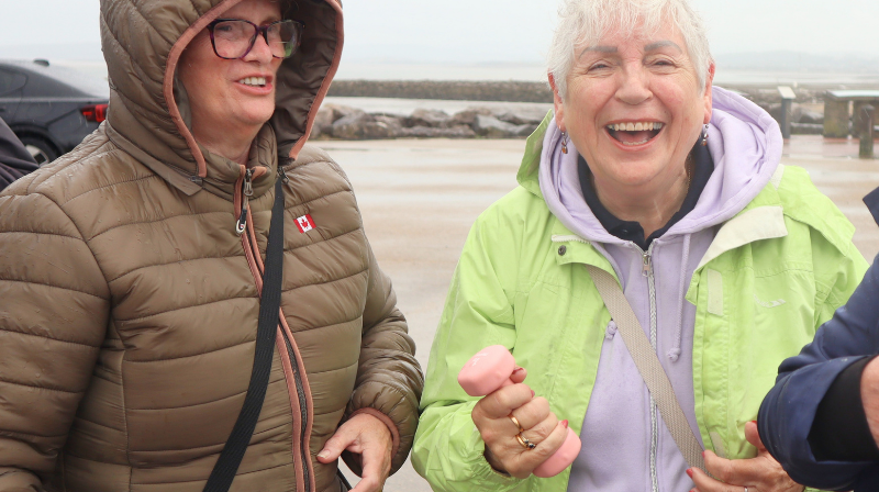 Two people smiling by the shore