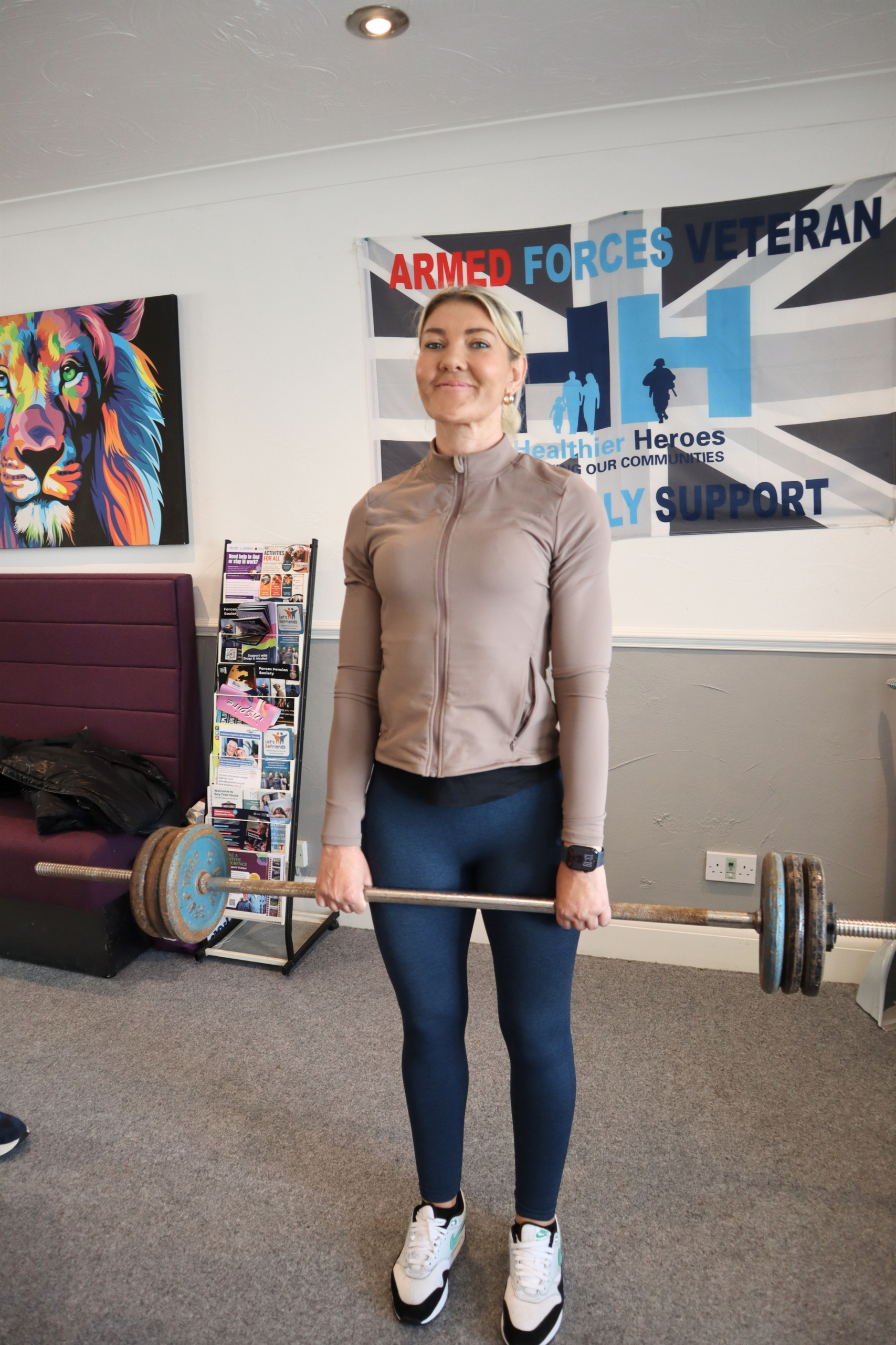Woman holding a barbell in a gym