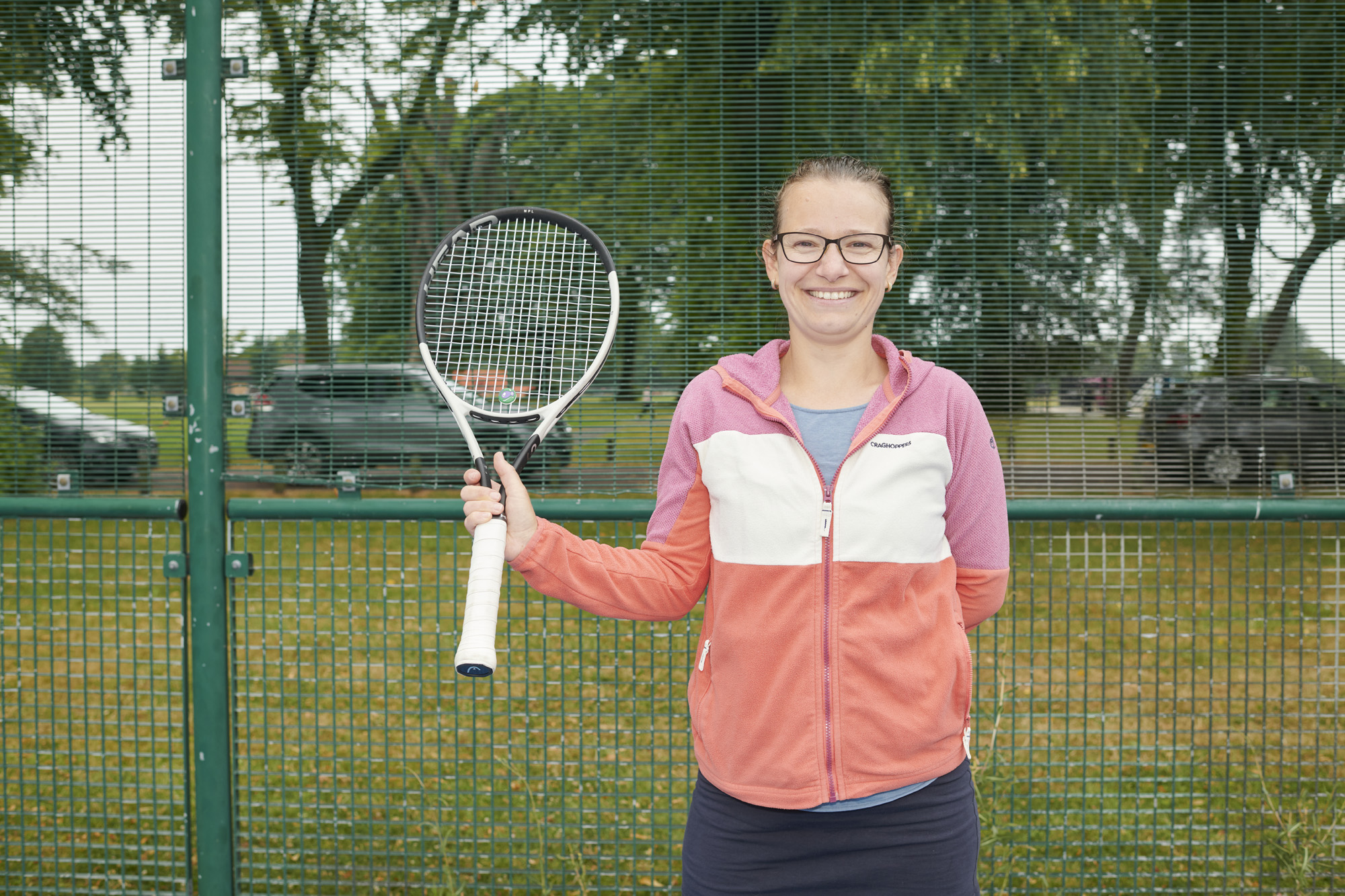Female holding tennis racket on tennis court at Moor Park