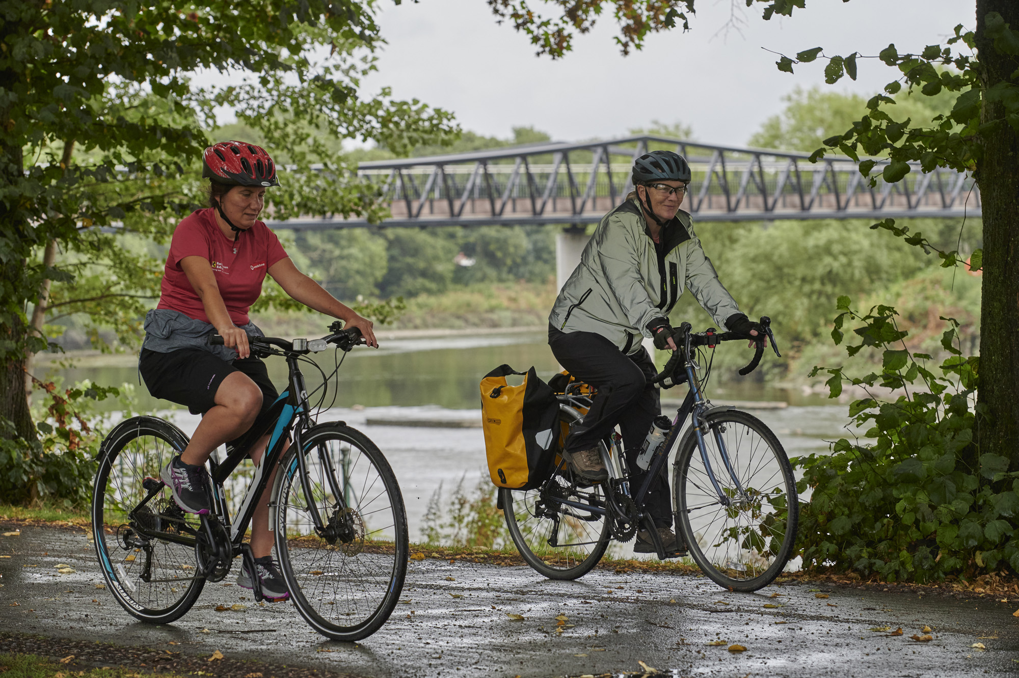 Two females, wearing helmets, cycling in Avenham and Miller Park
