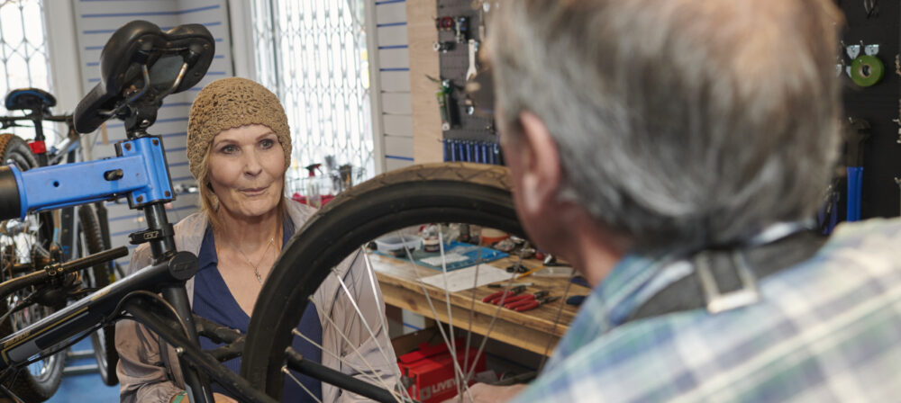Female with male holding tyre of bike at Preston Pedals