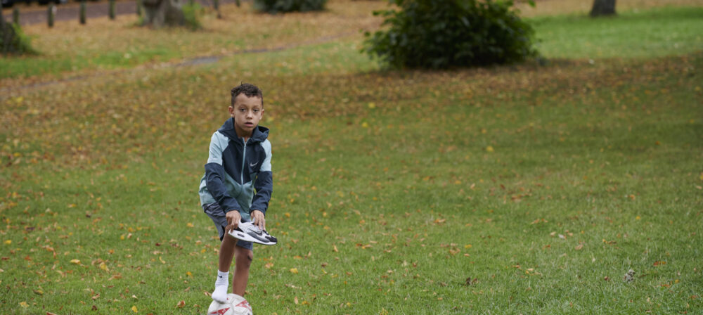 Young boy with football in Moor Park