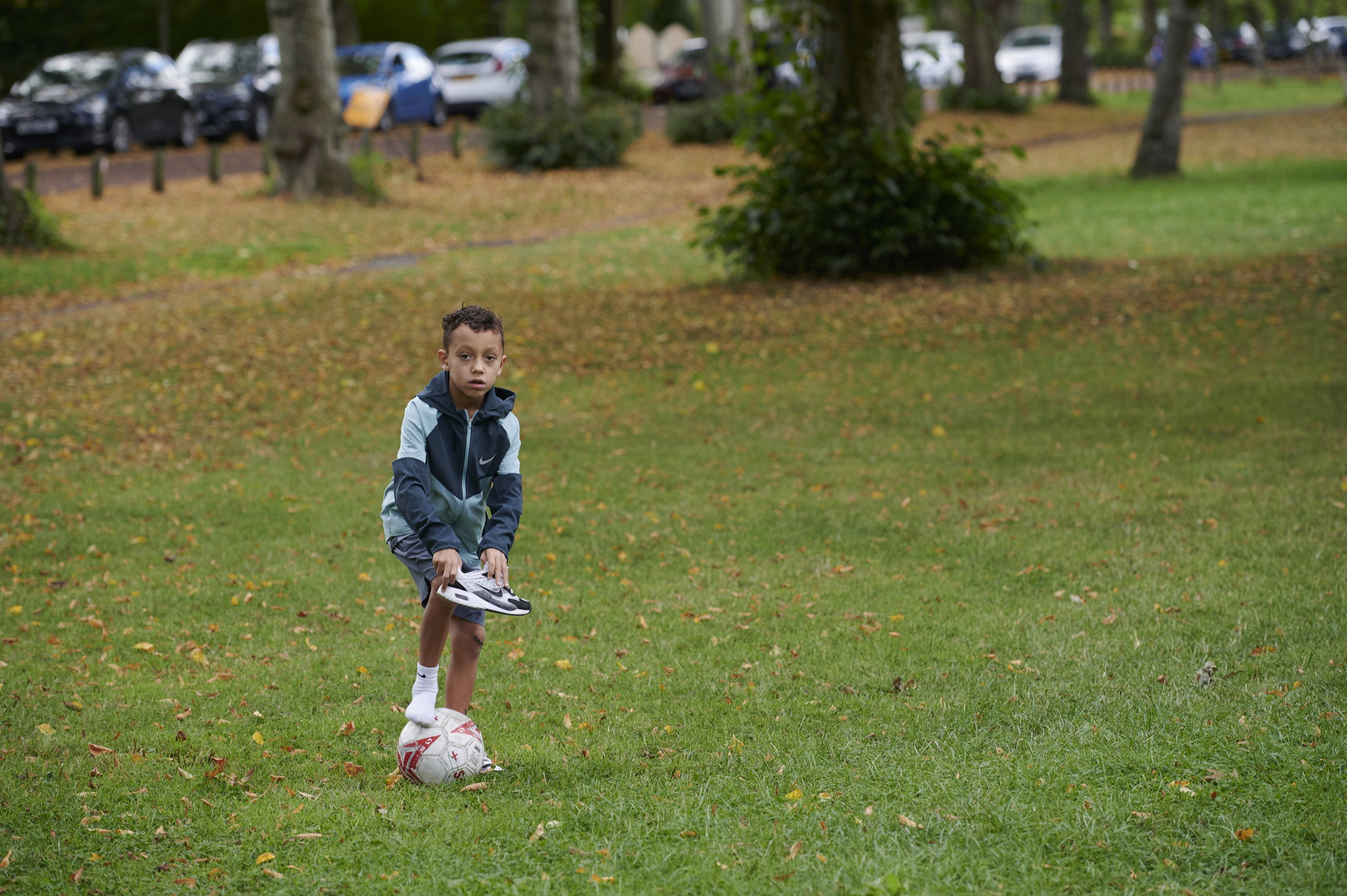 Young boy with football in Moor Park