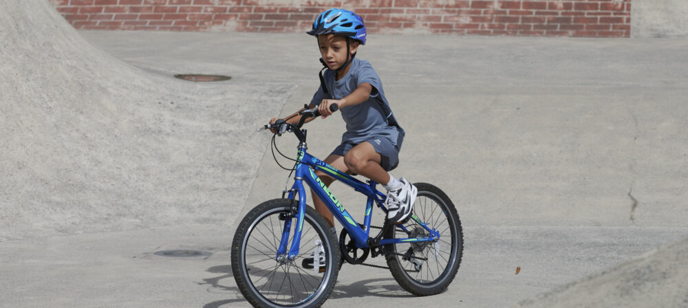 Young male cycling in Park wearing helmet