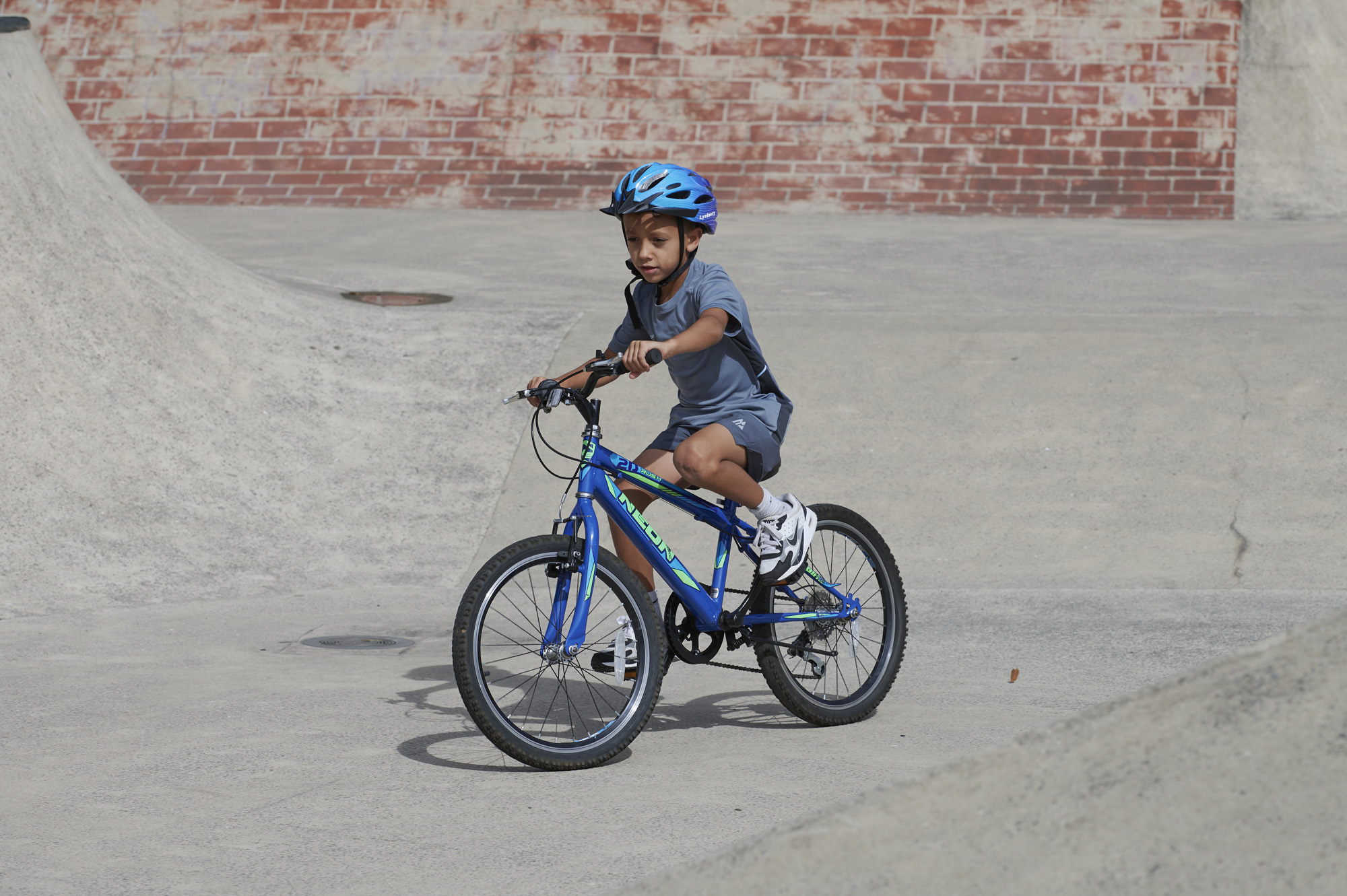Young male cycling in Park wearing helmet